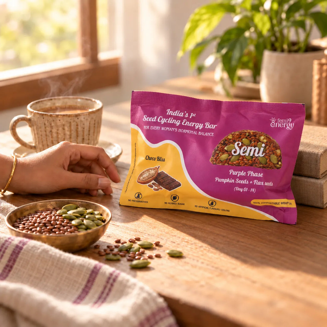A hand reaching for a Purple Semi Choco Bliss bar beside a cup of masala chai